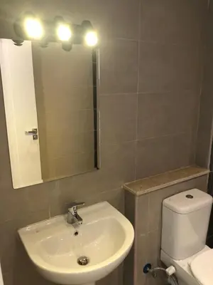 a bathroom with a sink and a toilet and a mirror at G cribs B15 in Hurghada