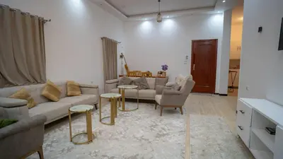 a living room with a couch and chairs and a table at hodhod luxor in Al Qurnah