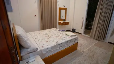 a bedroom with a bed in a room with a mirror at hodhod luxor in Al Qurnah
