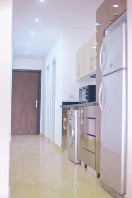 a kitchen with a washer and dryer in a room at selena bay resort in Hurghada
