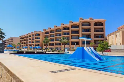 a swimming pool with a slide in front of a hotel at selena bay resort in Hurghada