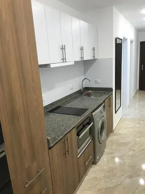 a kitchen with a sink and a washing machine at selena bay resort in Hurghada