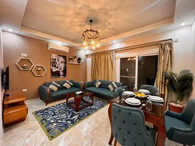 a living room with a couch and a table at selena bay resort in Hurghada