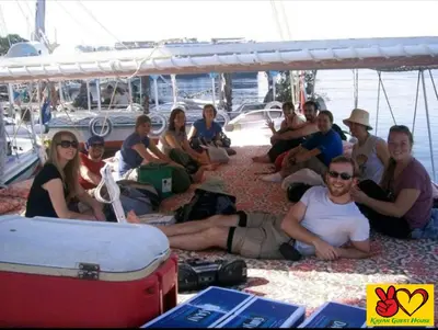a group of people sitting on a boat at Nubian Adventures - Felucca from Aswan to Kom Umbu in Aswan
