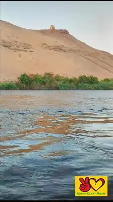 a painting of a body of water next to a sand hill at Nubian Adventures - Felucca from Aswan to Kom Umbu in Aswan