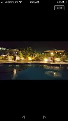 a picture of a swimming pool at night at منتجع لاكشيري جميع الرفاهيات و الكماليات in Hurghada