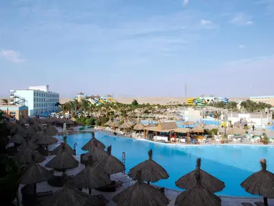 a view of a pool with umbrellas and a resort at Titanic Aqua Park Resort - Families and Couples only in Hurghada