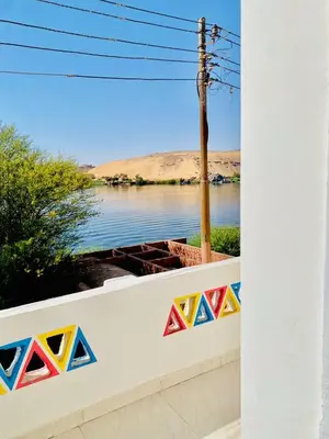 a wall with a view of a body of water at Dangy Kato in Aswan
