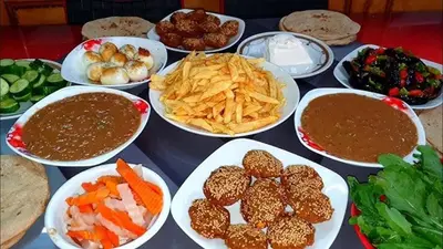 a table with plates of food and bowls of dip at Dangy Kato in Aswan