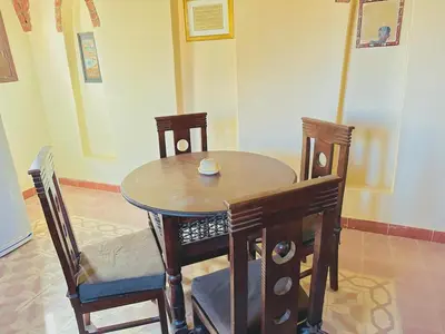 a wooden table and chairs in a room at King Tut in Luxor