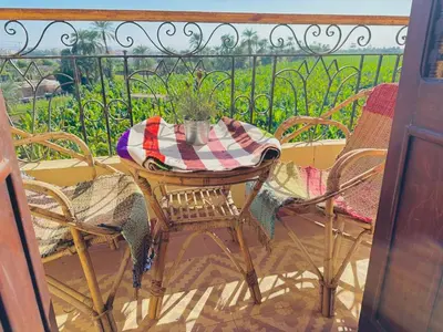 a table and chairs sitting on a balcony at King Tut in Luxor