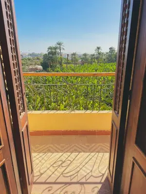 an open door to a balcony with a view at King Tut in Luxor