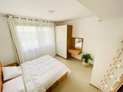 a bedroom with a large bed and a window at Sunny 1 BR Apt G cribs ElGouna with open View in Hurghada