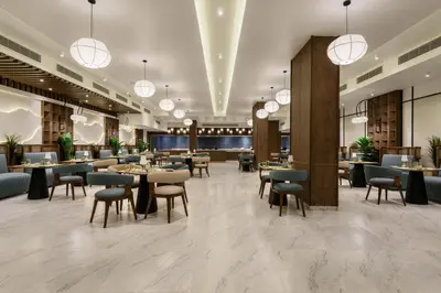 a restaurant with tables and chairs in a lobby at Flow Spectrum Resort Sahl Hasheesh in Hurghada