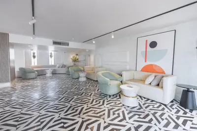 a living room with couches and chairs on a patterned floor at Flow Spectrum Resort Sahl Hasheesh in Hurghada