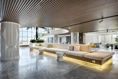 a lobby with couches and tables in a building at Flow Spectrum Resort Sahl Hasheesh in Hurghada
