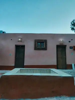 a building with three doors and a window at Abou El Leef villa in Luxor