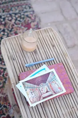 a wooden table with a candle and books on it at Abou El Leef villa in Luxor