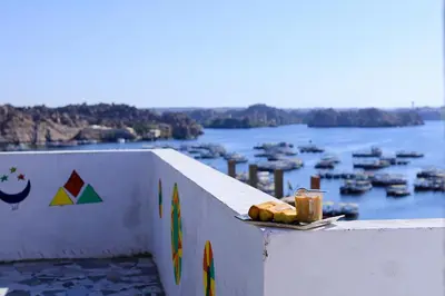 a plate of food on a ledge with a view of a harbor at dahab in Aswan