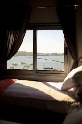 a window in a train looking out at the water at dahab in Aswan