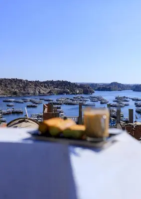 a plate of food on a table with a view of a city at dahab in Aswan