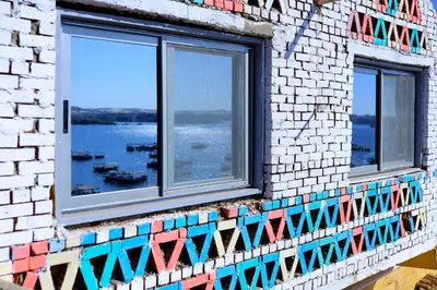 a brick wall with windows with a view of the water at dahab in Aswan