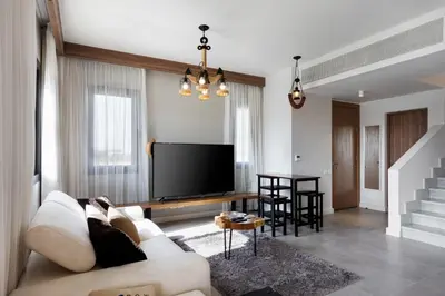 a living room with a couch and a flat screen tv at Fanadir Marina Front Penthouse with Pool in Hurghada