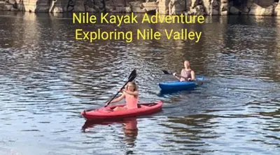 two girls are riding on kayaks in the water at Nile Kaiak Adventure in Aswan