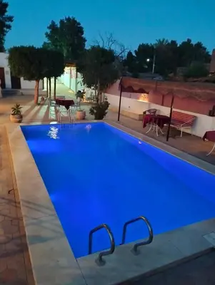a large blue swimming pool at night at Villa River Nile in Al Qurnah