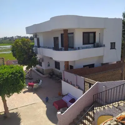 an aerial view of a white house with a balcony at Villa River Nile in Al Qurnah