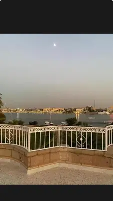a white railing with a view of the water at Villa Nile Queen -guest house in Luxor