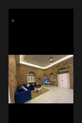 a living room with a blue couch and a table at Villa Nile Queen -guest house in Luxor
