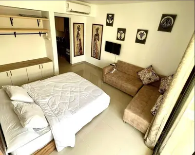 a living room with a bed and a couch at Studio Escape G Cribs in Hurghada