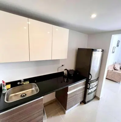 a kitchen with a sink and a refrigerator at Studio Escape G Cribs in Hurghada