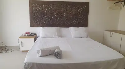 a bedroom with a large white bed with towels on it at Studio Escape G Cribs in Hurghada