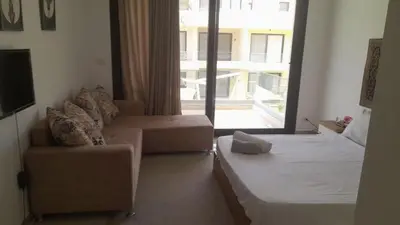 a living room with a bed and a couch and a window at Studio Escape G Cribs in Hurghada