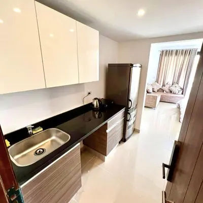 a kitchen with a sink and a refrigerator at Studio Escape G Cribs in Hurghada