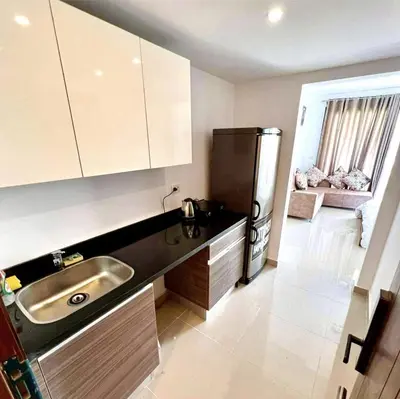 a kitchen with a sink and a refrigerator at Studio Escape G Cribs in Hurghada