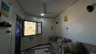 a living room with a couch and a window at Aswan apartment-Center of Aswan in Aswan