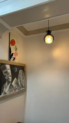 a room with a lamp and a picture on the wall at Aswan apartment-Center of Aswan in Aswan