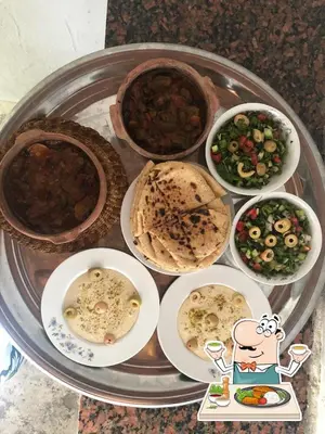 a tray with different types of food on a table at Ibiza Guest House in Aswan