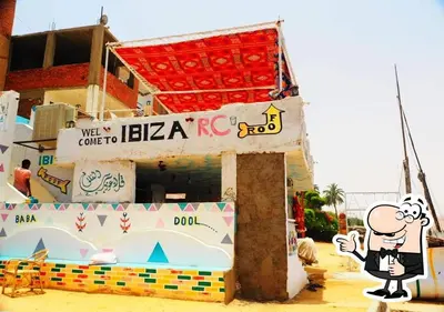 a cartoon character standing in front of a building at Ibiza Guest House in Aswan