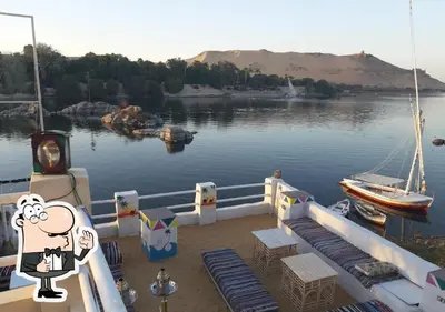 a boat in a body of water with a cartoon at Ibiza Guest House in Aswan