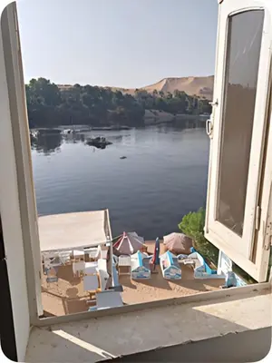 an open window with a view of a body of water at Ibiza Guest House in Aswan