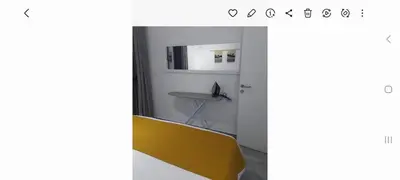 a bathroom with a yellow bench in a room at Spacious and modern one bed in hurhgarda in Hurghada