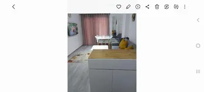a kitchen with white cabinets and a dining room at Spacious and modern one bed in hurhgarda in Hurghada