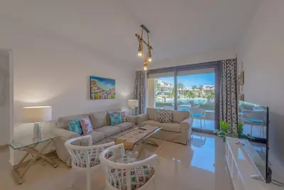 a living room with a couch and a table at Chic 2 BR poolside Apartment at G-crib El Gouna in Hurghada