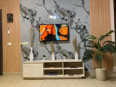 a living room with a tv on a wall at Al Dau Heights in Hurghada