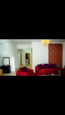 a living room with red couches and a television at C and S park in Hurghada