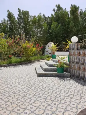 a patio with potted plants and a stone floor at C and S park in Hurghada